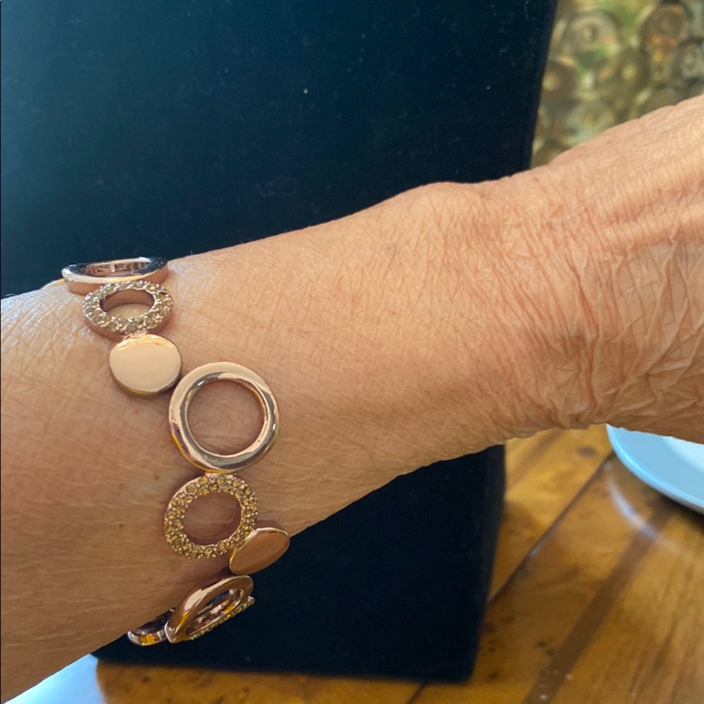 Fossil Gold Circular Link Bracelet. It has an elastic band
